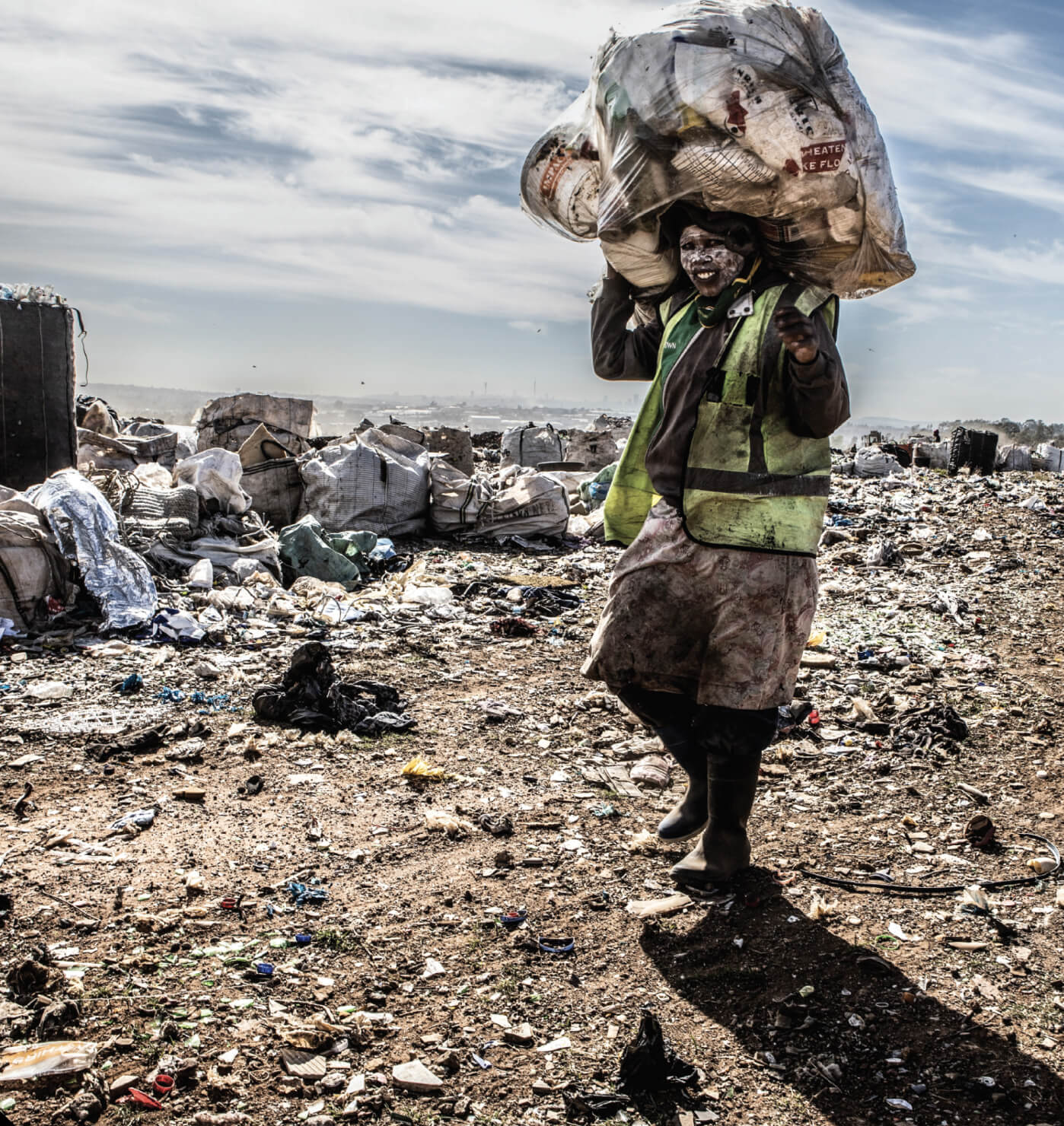 Marie Louise landfill site. A waste picker collects recyclable goods, enormous volumes of waste are being diverted from landfill sites through the work of waste pickers.