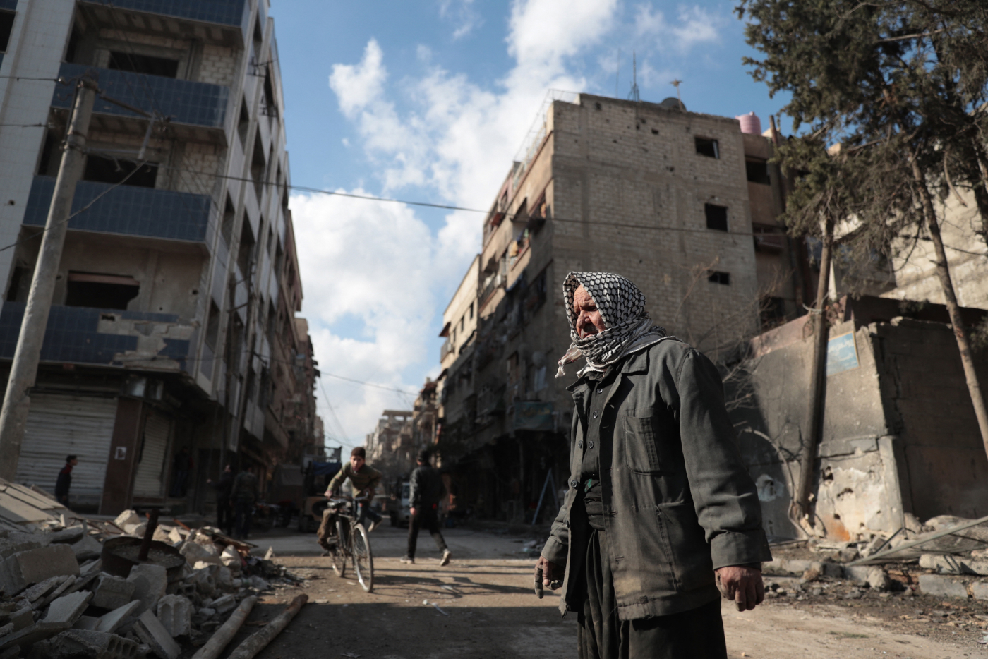 Syrian Abu Khaled looks at the rubble of his destroyed house in the rebel-held town of Douma, on the eastern outskirts of Damascus, on December 30, 2016, on the first day of a nationwide truce. Clashes erupted between Syrian government forces and opposition fighters in an area outside Damascus, despite a nationwide truce that began at midnight, a monitor said.